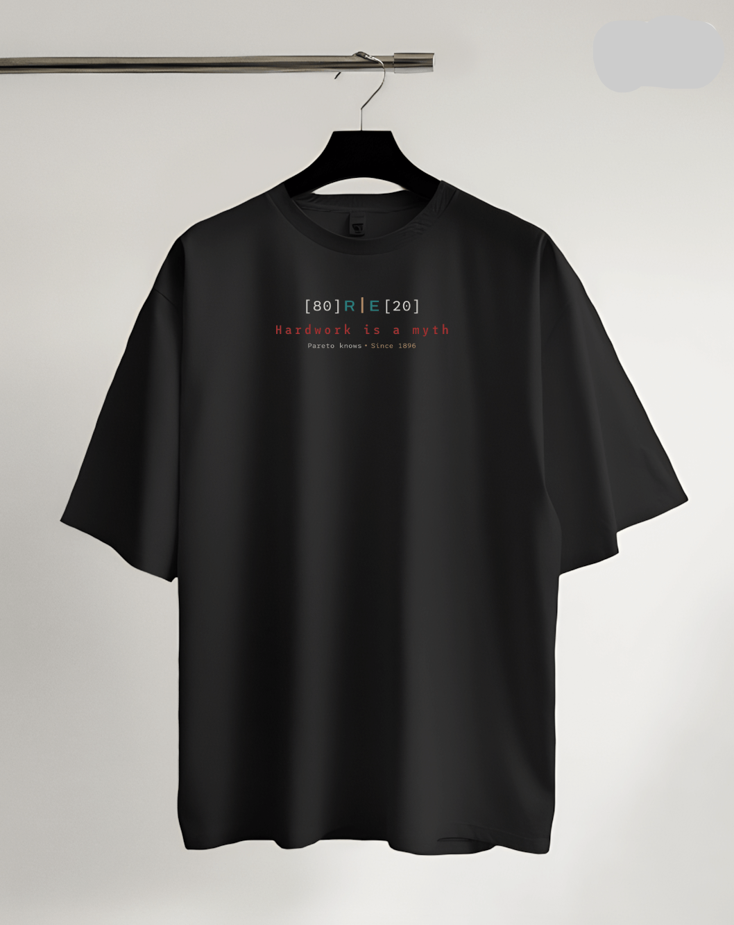 Black t-shirt with text on a hanger against a light gray background